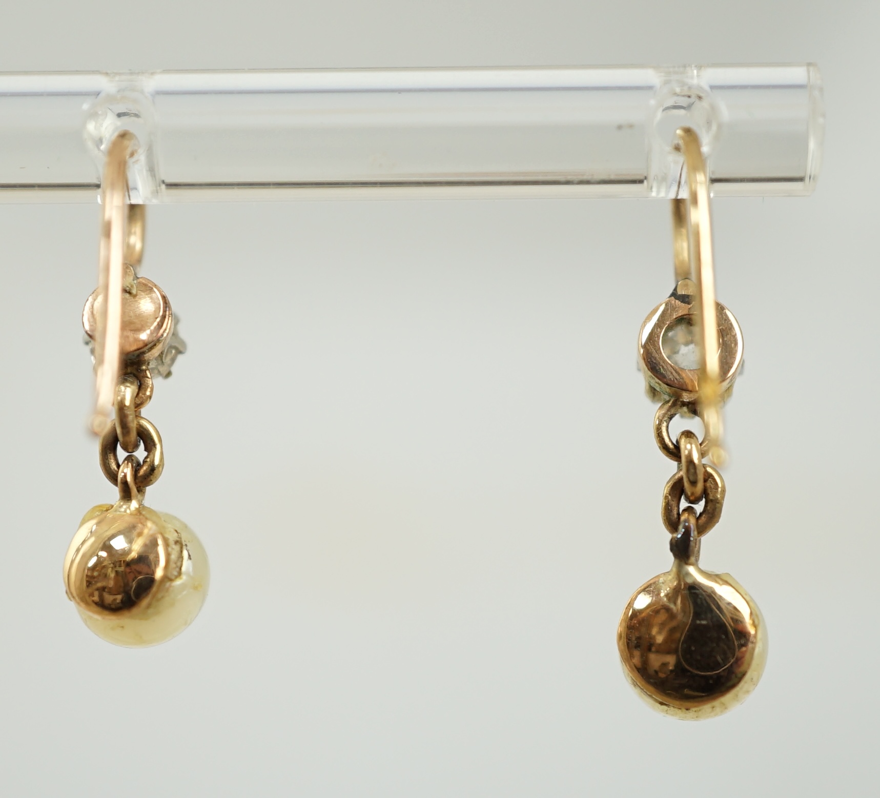 A pair of late 19th/early 20th century gold, single stone diamond and single stone button pearl set drop earrings